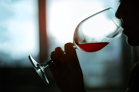 Silhouette Beautiful Young Woman Drinking Wineの写真素材