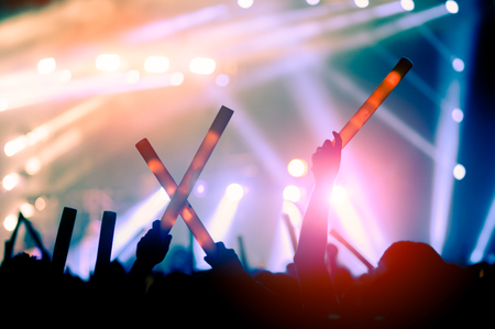 silhouettes of hand in concert.Light from the stage.の写真素材