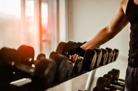 Rows of dumbbells in the gym with hign contrast and monochrome color tone.の写真素材