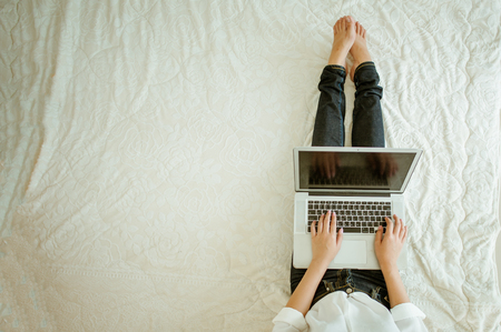 Top view of girl typing on laptop.Young man sitting on floor with laptop.Portrait of a young woman sitting on the floor and using laptop.beautiful women owner business woman work at home.の写真素材