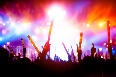 silhouettes of hand in concert.Light from the stage.の写真素材