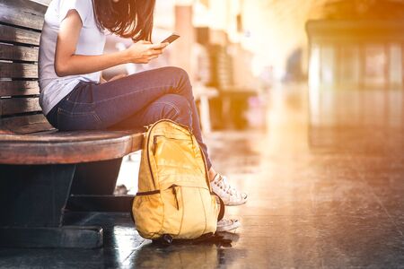 Traveler woman  waits train on railway platform.の写真素材