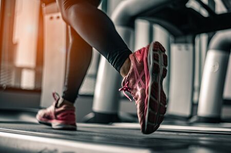 Close up on shoe,Women running in a gym on a treadmill.exercising concept.fitness and healthy lifestyle の写真素材