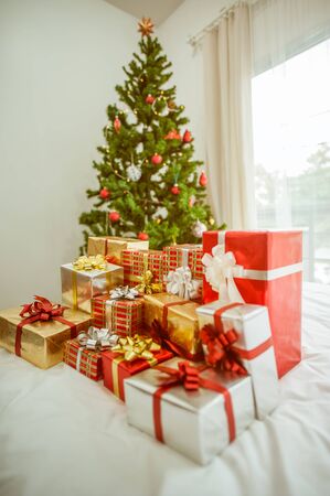 Stacks of Christmas presents under a Christmas tree.の写真素材
