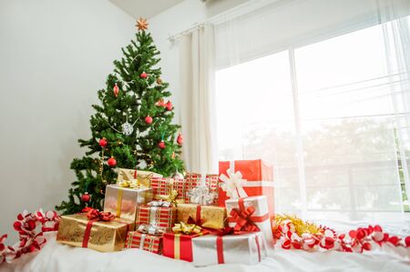 Stacks of Christmas presents under a Christmas tree.の写真素材