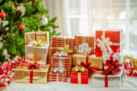 Stacks of Christmas presents under a Christmas tree.の写真素材