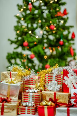 Stacks of Christmas presents under a Christmas tree.の写真素材