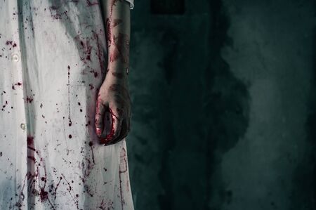 bloody hand of Ghost woman in the dark. nightmare, horror of scary fear on hell is monster devil in halloween festival, copy space the right.の写真素材