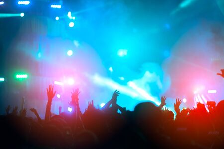 silhouettes of hand in concert.Light from the stage.の写真素材