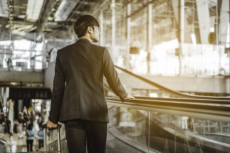 Businessman moving to terminal gate for check in boarding with luggage at the airport to business trip.の写真素材