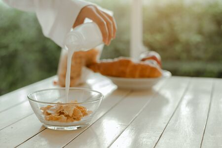 Young woman asia wake up refreshed in the morning and relaxing eat coffee, cornflakes, bread and...