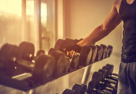Rows of dumbbells in the gym with hign contrast and monochrome color tone.の写真素材