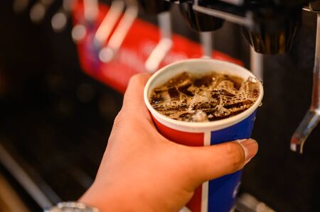 man pours a fizzy drink.sparkling water.cool ice soft drink colaの写真素材