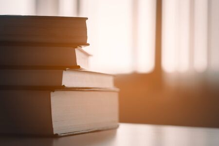 Book in library.Book stack on wood desk.ducation background, back to school concept.の写真素材