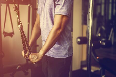 Muscular fitness man doing workout.Concept of healthy lifestyle. Cross fit bodybuilder in the gym. の写真素材