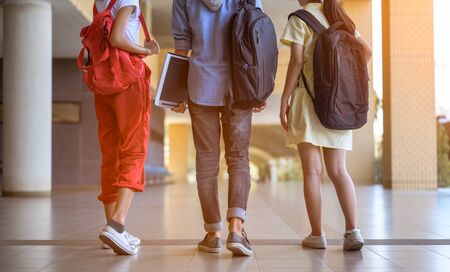A group of students are walking to school. Students carry bags and have school equipment.
の写真素材