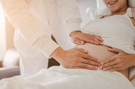Doctor examine pregnant healthcare check up for baby and mother  at hospital or clinic. Pregnant woman is happy visit gynecologist for pregnancy consultant. Prenatal care and pregnancy concepts of motherhood.の写真素材