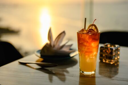 Glass of cocktail a shadow on the sky bar counter in restaurant. Cocktail is perfect for a summer break. Cocktail, beverage, alcohol, relax, restaurant, summer concept.の写真素材