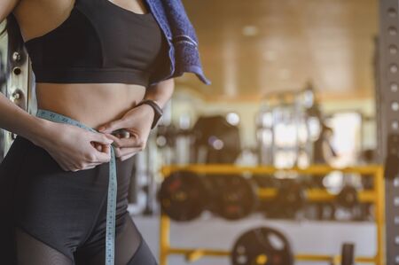 fitness, diet, gym, exercise, lifestyle and healthy concept. Women exercise to lose weight, Women who wear sportswear and exercise for diet. Workout concept.の写真素材