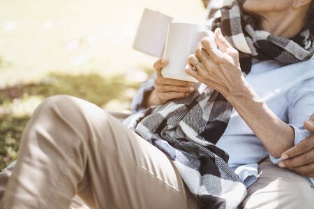 Senior, couples, retirement, insurance, elderly, lifestyle concept.  Senior couples sitting and talking on the outdoor lawn in the morning about life insurance plans with a happy retirement concept.の写真素材