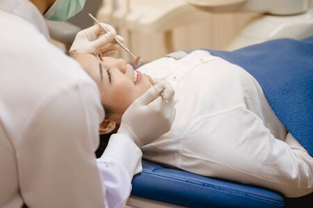 Dentist examining  teeth patients in clinic for better dental health and a bright smile.