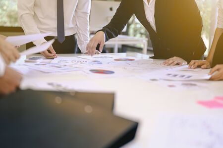 The business boss spends time planning a new financial project with his employees at the company. Teamwork, teamwork concepts for business partners, meetings, and greeting concepts.の写真素材