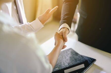 Commander handshaking new employee congratulating with starting a new job. Teamwork collaboration concept for business partners, Meetings and greetings concepts.の写真素材