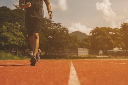 Man runner ready for sports exercise in the sunset on the race track.の写真素材