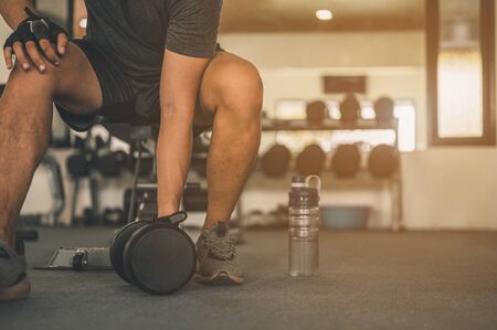 Bodybuilder working out with dumbbell weights at the gym.man bodybuilder doing exercises with dumbbell. Fitness muscular bodyの写真素材