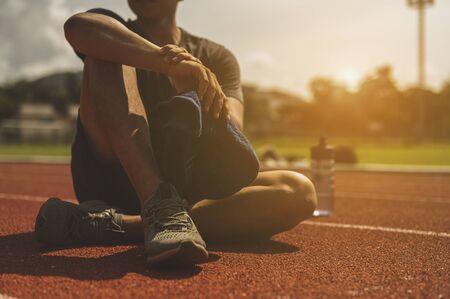 The young man wore all parts of his body to prepare for jogging on the running track around the...