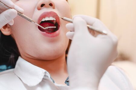 Dentist examining  teeth patients in clinic for better dental health and a bright smile.の写真素材