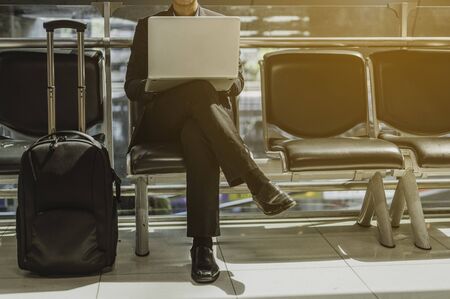 Businessman with laptop at the airport.Travel and business airport concept.の写真素材