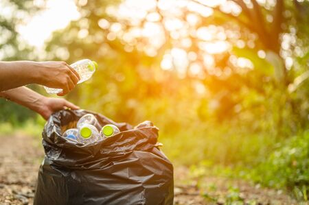 Collect plastic bottles in the garden.Environmentalism & Plastic Awareness.Forest clean-ups.の写真素材