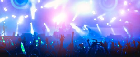 silhouettes of hand in concert.Light from the stage.の写真素材