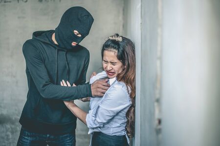 Thieves are trying to rape women.の写真素材