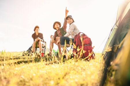 man and woman sitting in chairs on camp.の写真素材