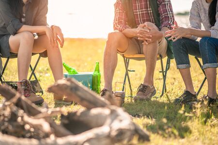 man and woman sitting on chairs at camp. の写真素材