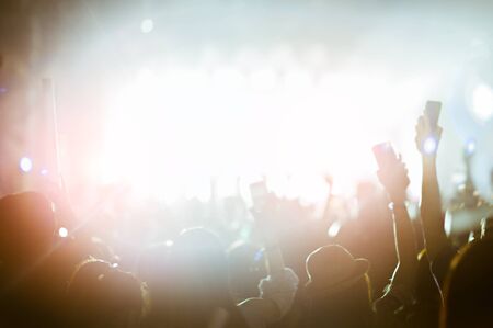 silhouettes of hand in concert.Light from the stage.の写真素材