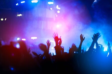 silhouettes of hand in concert.Light from the stage.の写真素材