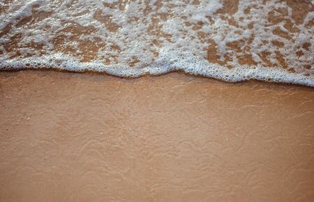 Soft wave on sandy beach. Background.の写真素材