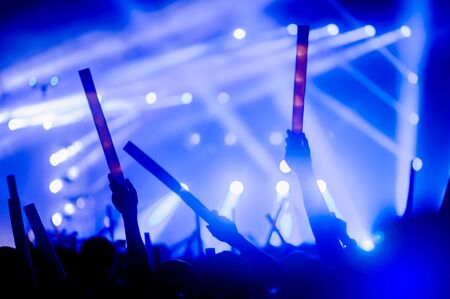 silhouettes of hand in concert.Light from the stage.の写真素材