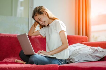 young beautiful woman using a laptop computer at homeの写真素材