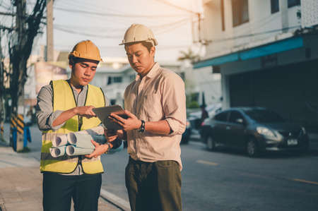 Couple of engineer discussing of construction about the plan the project were at the job site. Engineer, Engineering, Architecture, Design, Planning, Occupation concept.の写真素材