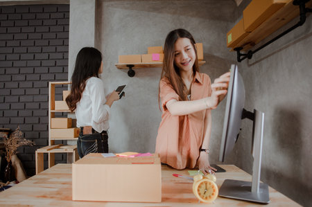 Young woman asian work from home talking with customers to sell products online and delivery for customer. Business owner, SME, shipping, work from home(WFH), freelance, Start up concept.の写真素材