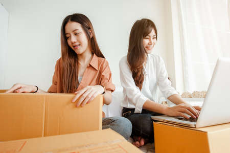 Young woman asian work from home online marketing packaging and delivery for customer at home. Business owner, SME, shipping, work from home(WFH), freelance, Start up concept.の写真素材