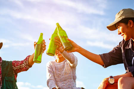 Team of asian climbers hiker are sitting and enjoying a drink after a set up outdoor tent in the forest path autumn season. Hiking, hiker, team, forest, camping , activity concept.の写真素材