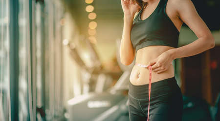 Women asia exercise to lose weight, Women who wear sportswear and exercise for diet. Workout concept. fitness, diet, gym, exercise, lifestyle and healthy concept.の写真素材