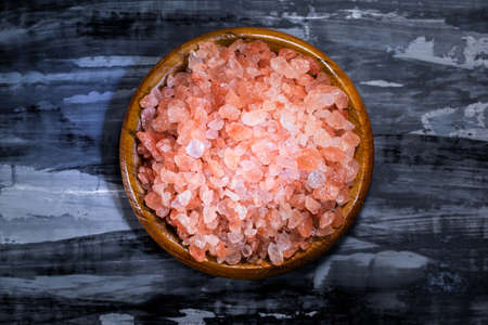 Pink Himalayas salt isolated pile on rustic black background close up, top view, food and drink concept.の写真素材