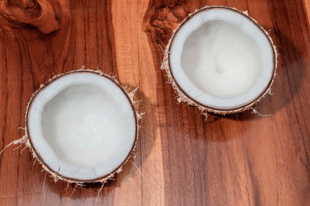 Half coconut on wood background, top view, healthy food concept.の写真素材