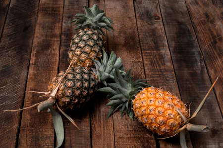 Pineapple on wood background, top view, healthy fruit food concept.